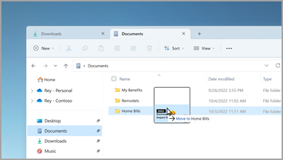 Drag and drop files between tabs in File Explorer.